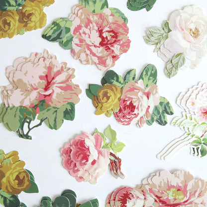 Virginia Die Cut Embellishments are colorful paper cutouts of flowers and green leaves, ideal as floral die cut stickers or scrapbook accents, beautifully displayed on a white background.