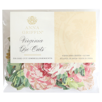 A clear package labeled "Virginia Die Cut Embellishments" contains 84 floral stickers in pink and green patterns, ideal for use as scrapbook embellishments.