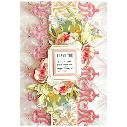 Create elegant borders for cards or scrapbook pages with the 12" Grand Trimmings Border Dies, featuring pink and gold ornamental patterns, floral accents, and a central "Thank you from the bottom of my heart" label.