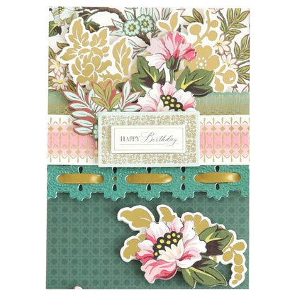 A birthday card from the Jasmine Papercrafting Collection, featuring floral designs in pink, gold, and green with elegant die-cut borders and a central "Happy Birthday" message.