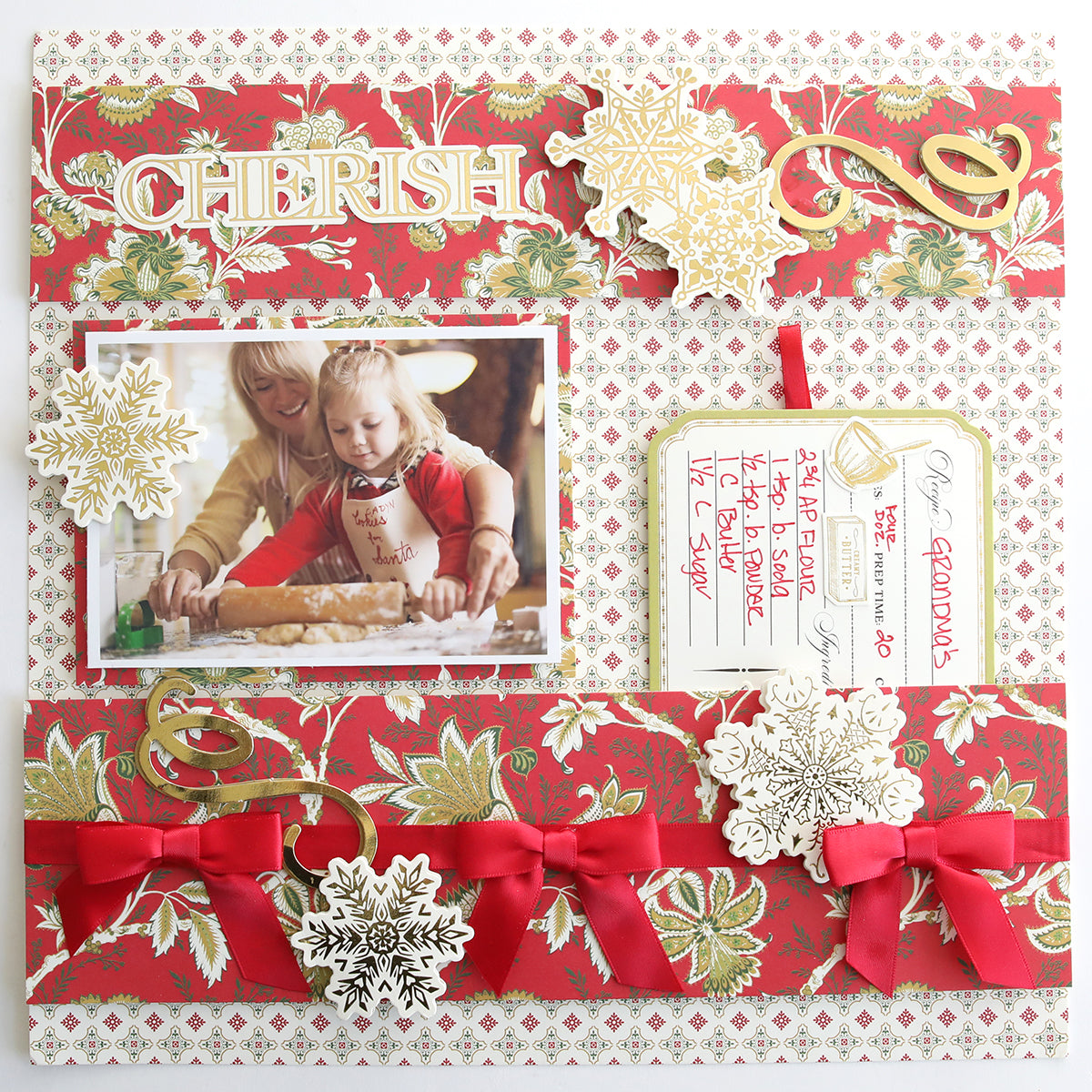 A festive scrapbook page featuring two people baking, elegant gold and white snowflakes from the Jasmine Holiday Cardstock Collection, red bows, "Cherish," and a handwritten recipe card—perfect holiday card inspiration.