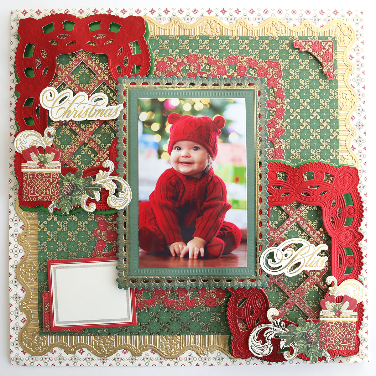 Scrapbook page with a baby in red, festive "Christmas" and "Bliss" accents, and ornate red, green, and gold decorations crafted from the Jasmine Holiday Cardstock Collection and 300 gsm cardstock.