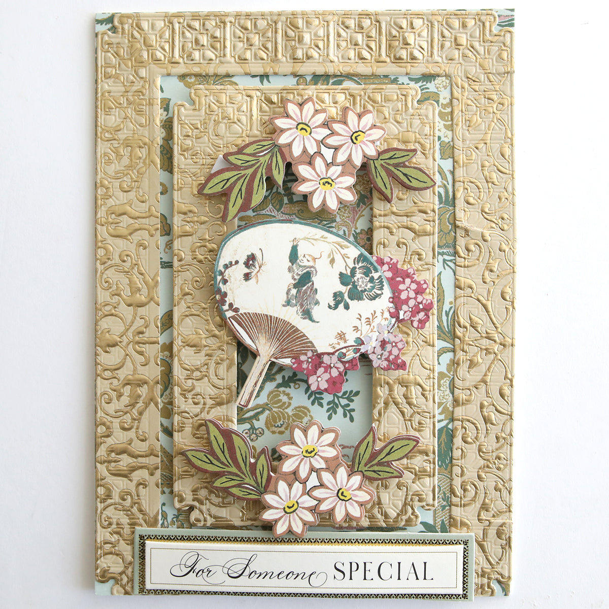 A decorative card made from Jasmine Luxury Tonal Foil Cardstock features embossed gold patterns, floral designs, an ornate fan, and the phrase “For Someone SPECIAL” at the bottom.