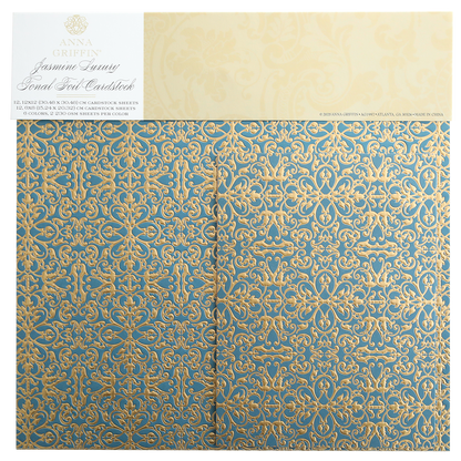 The Jasmine Luxury Tonal Foil Cardstock has ornate blue and gold scrolls on foil-embossed paper, ideal for crafting. The "Anna Griffin Jasmine Luxury" label at the top adds a premium touch.