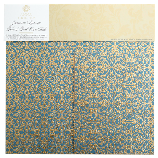 The Jasmine Luxury Tonal Foil Cardstock has ornate blue and gold scrolls on foil-embossed paper, ideal for crafting. The "Anna Griffin Jasmine Luxury" label at the top adds a premium touch.