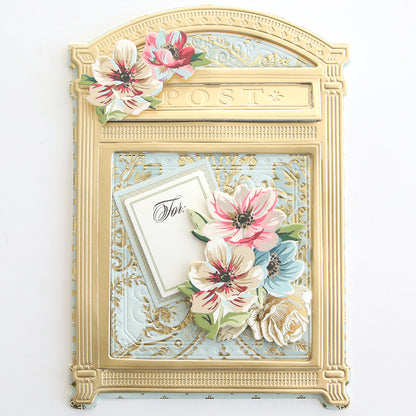 The Create Everyday Embellishments set features a gold and blue card shaped like a vintage mailbox, decorated with die-cut details, layered floral blooms, and finished with a charming "For You" tag.