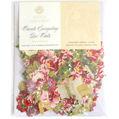 A package of Create Everyday Embellishments is shown in clear packaging, containing 84 layered floral blooms and embellishments for creative projects.