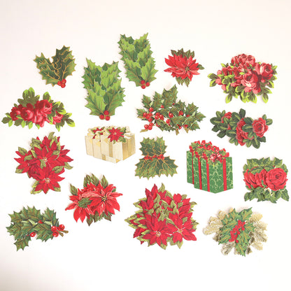Create Holiday Embellishments features assorted layered die cuts with Christmas-themed designs like poinsettias, holly leaves with berries, roses, pine sprigs, and wrapped gifts on a white background.