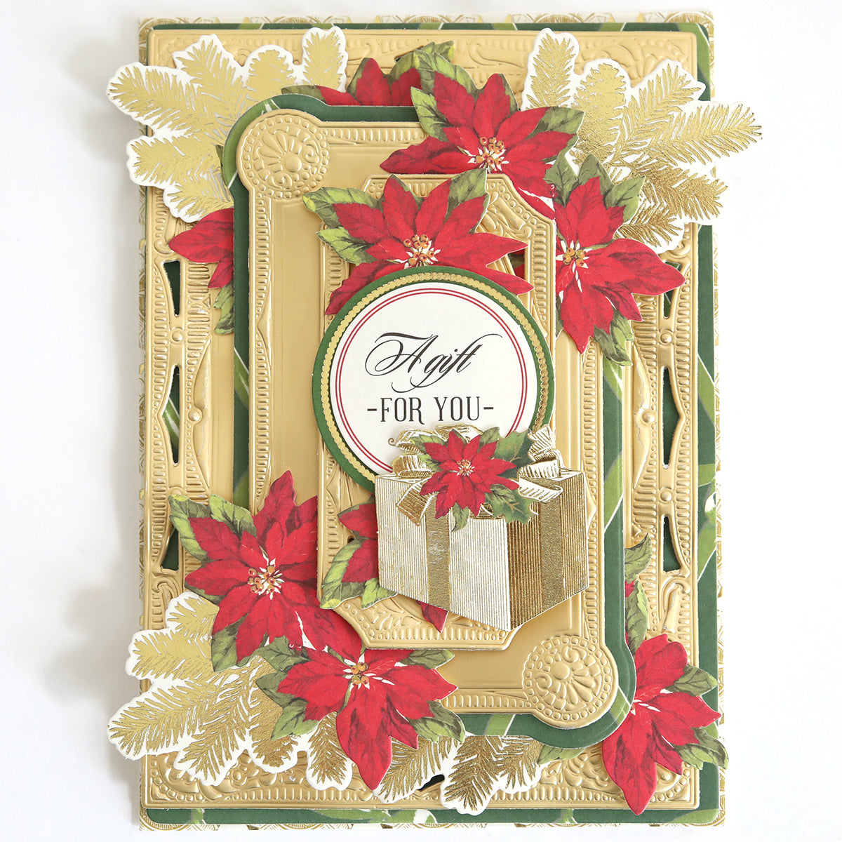 The Create Holiday Embellishments card features a gold frame, festive poinsettias, green foliage, and a gift box with layered die cuts plus "A Gift For You" text in the center.