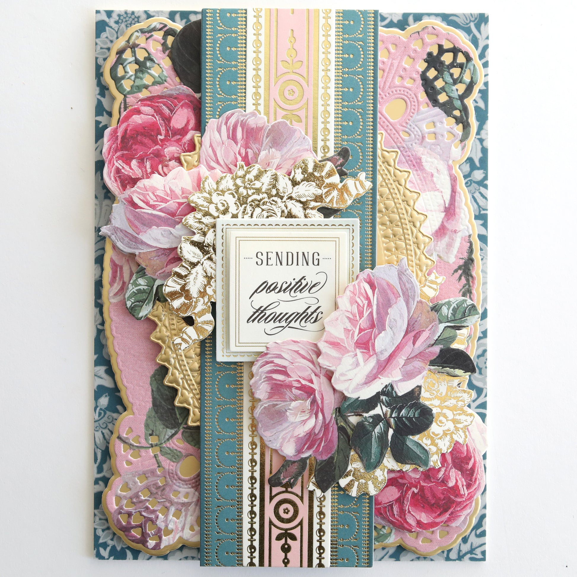 A decorative greeting card from the Jasmine Papercrafting Collection, featuring layered floral designs, gold accents, “Sending positive thoughts” at the center, and elegant die-cut borders.