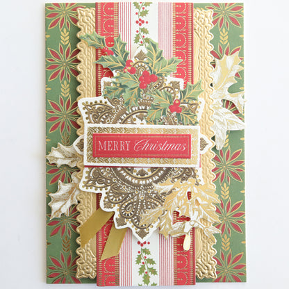 A decorative Christmas card with gold, red, and green patterns featuring holly and a "Merry Christmas" label—perfect for festive crafting or embellishing with Create Holiday Border Stickers.