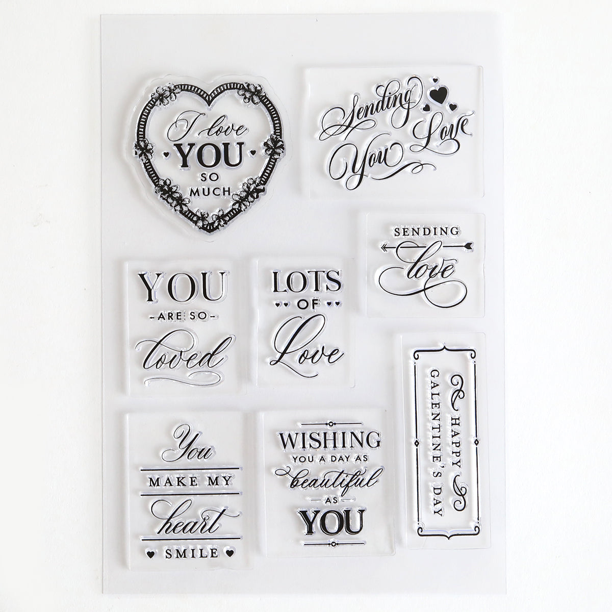 Lovely Sentiment Stamps are decorative clear stamps featuring romantic phrases like "I love you so much" and "Happy Valentine's Day" in ornate lettering—ideal for handmade cards or charming scrapbook pages.