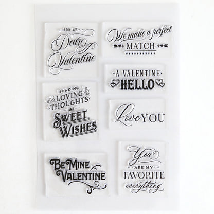 The Lovely Sentiment Stamps set includes seven clear stamps with romantic phrases like "Love You" and "Be Mine Valentine," perfect for decorating scrapbook pages or making heartfelt handmade cards.