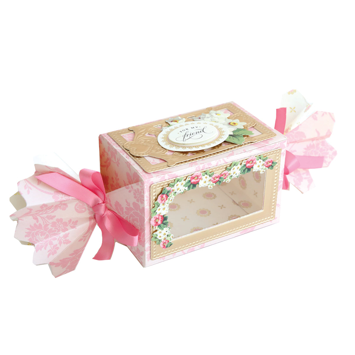 The Candy Wrapper Box Dies create a rectangular treat box with a clear window, pink patterned sides, and pink ribbon accents—ideal for favor boxes or gifting sweets.