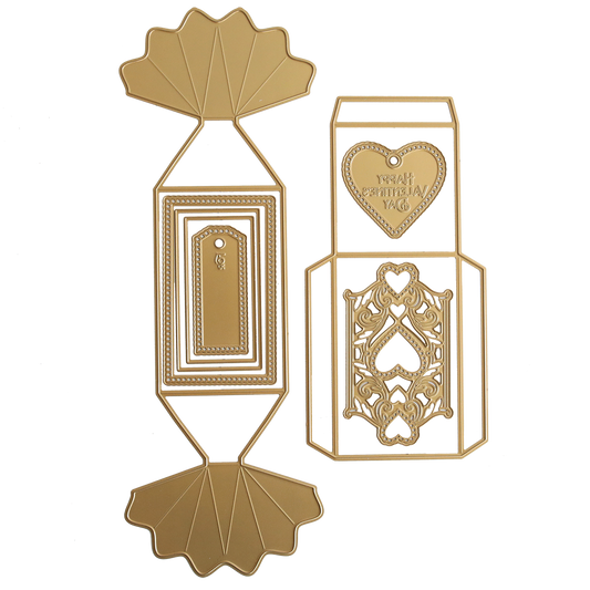 The Candy Wrapper Box Dies set includes two gold metal templates for crafting treat or favor boxes, featuring geometric designs, a heart with "Happy Valentine's Day," and detailed decorative accents.