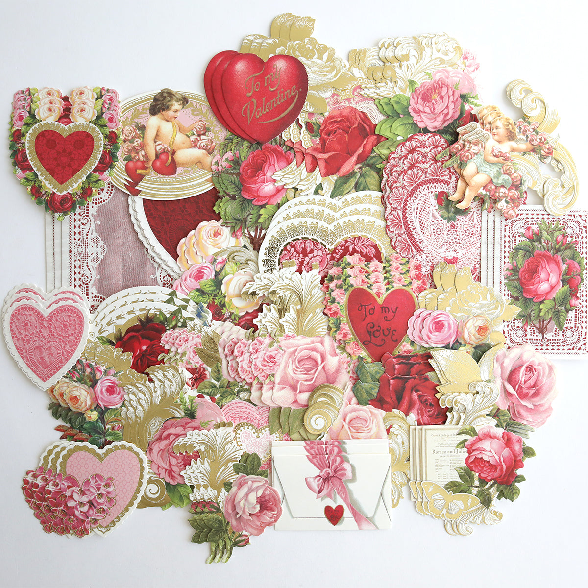 Vintage Valentine Die Cut Embellishments—an assortment of cards and decorations with hearts, roses, cherubs, and Victorian designs—perfect for crafts or decor, arranged on a white background.