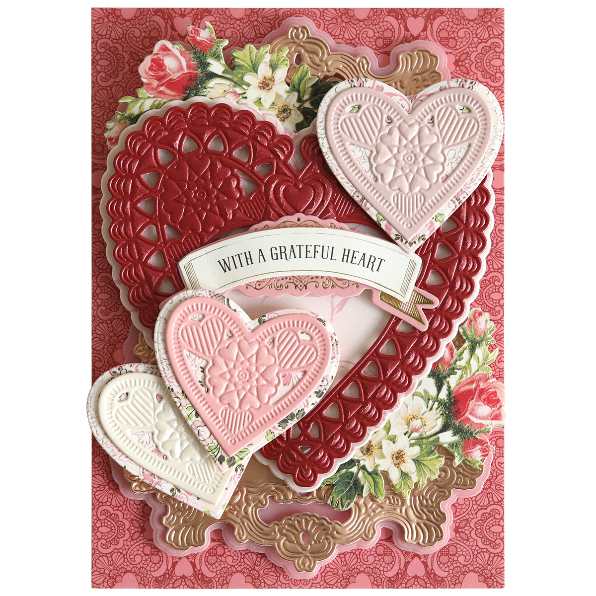 A handmade card featuring layered hearts made with 3D Concentric Heart Dies, floral accents, and a "With a Grateful Heart" banner on red patterned paper—ideal for Valentine’s Day crafts.