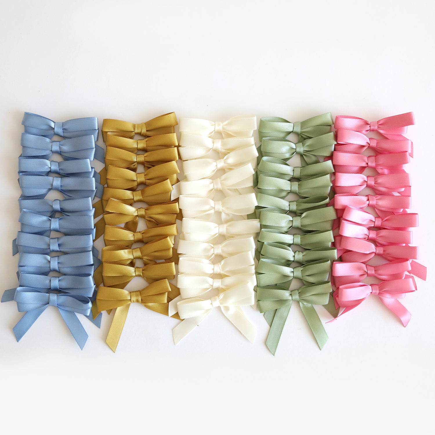 Perfect Double Bows 50 count—ten rows of satin bows in blue, gold, ivory, green, and pink on a white background. These pre-tied bows are ideal craft embellishments for all your projects.
