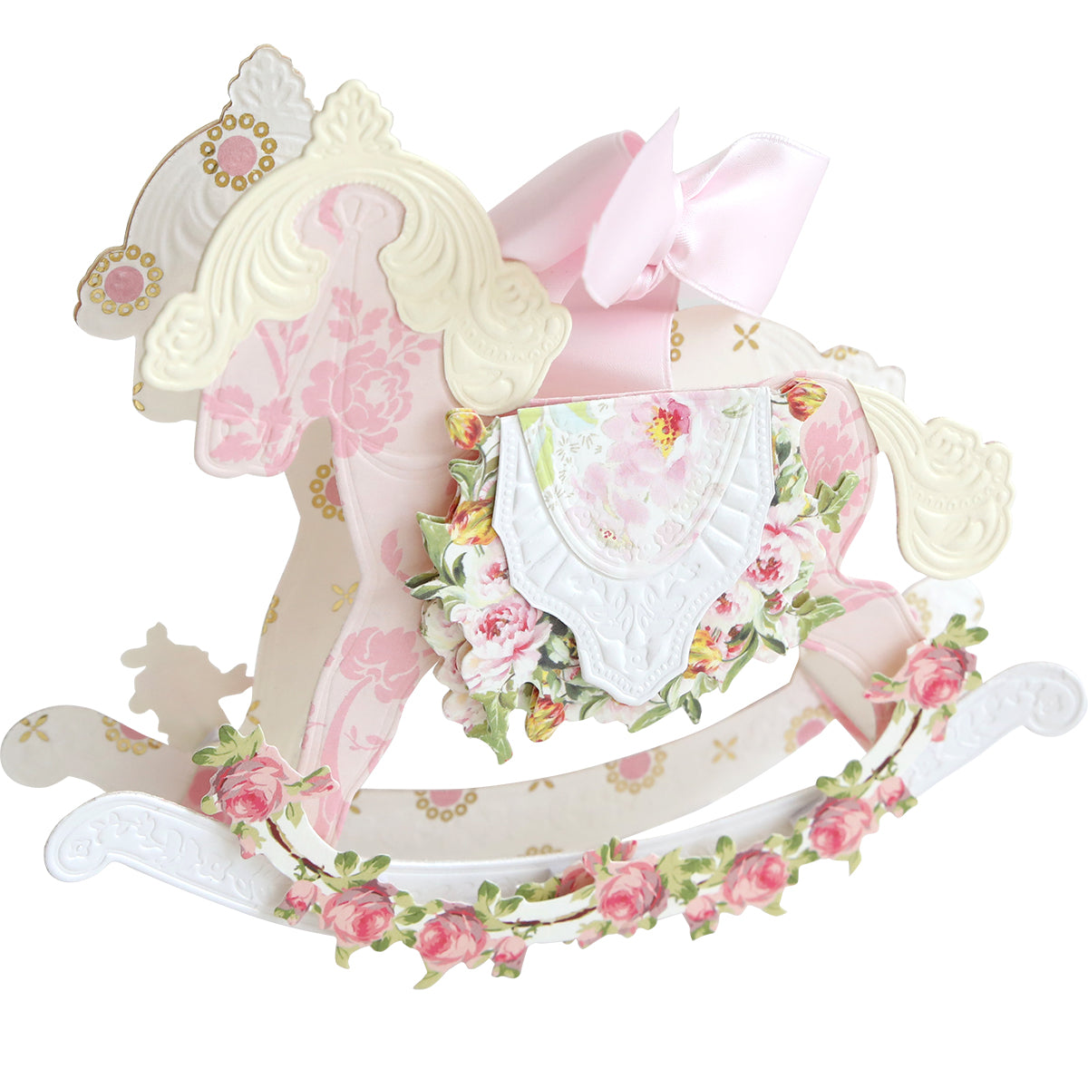 A decorative pastel pink and white paper cut-out made with Rocking Horse 3D Dies, featuring floral patterns, gold accents, and a pink bow—perfect for holiday crafts or baby milestone celebrations.