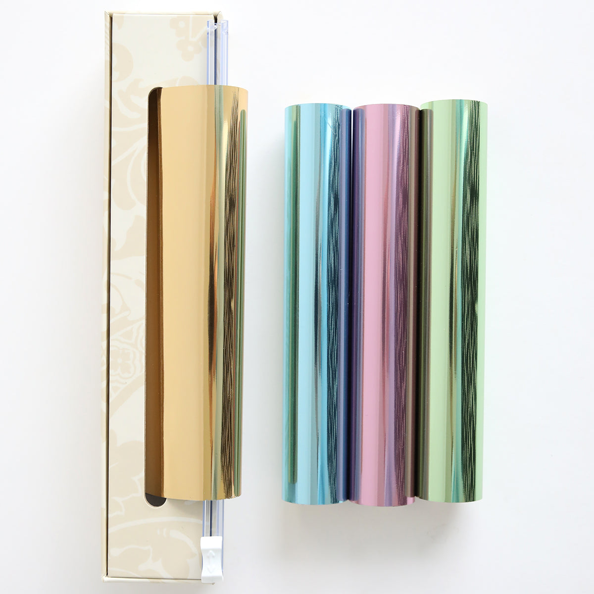 The Perfect Palette Pastel Gild Hot Foil includes three metallic rolls in gold, blue, and pink-green, packaged in a gold-patterned box—ideal for adding shimmer to paper crafts.