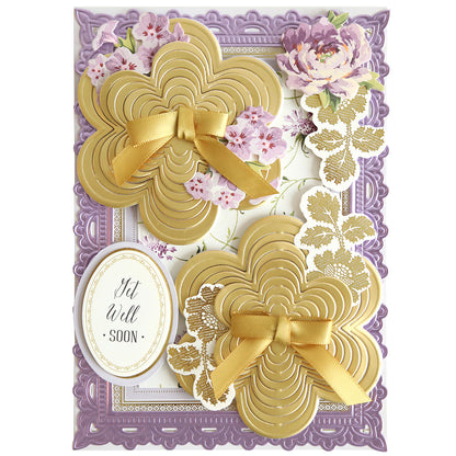 A rectangular Butterfly Garden Kirigami and Embellishments greeting card featuring two gold-layered butterfly flower die shapes, gold ribbons, floral cutouts, and a “Get Well Soon” oval tag.