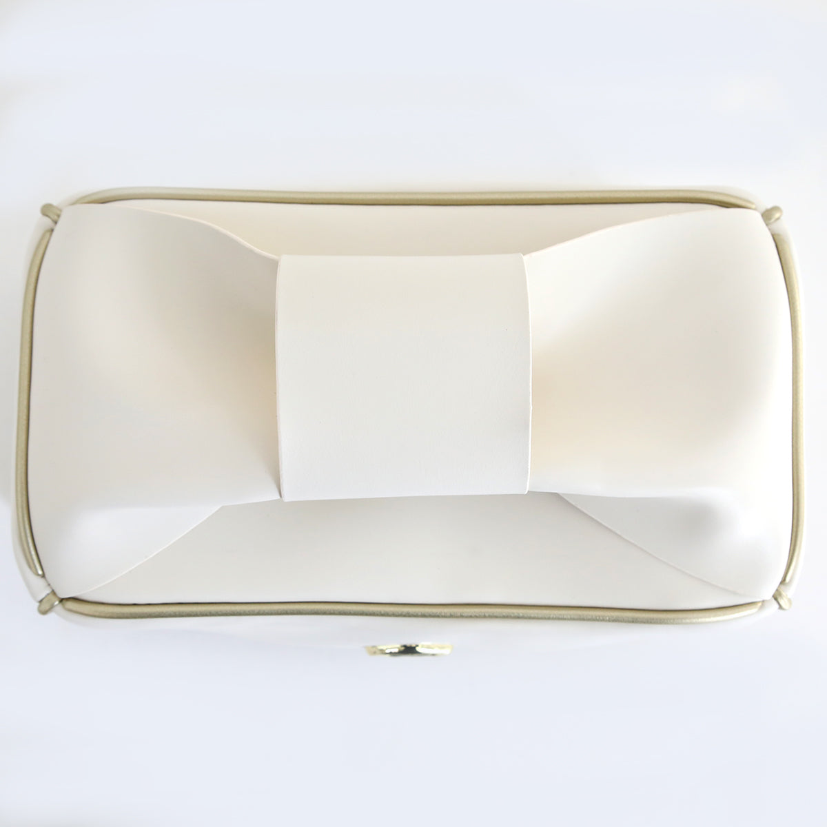 The Empress Mini Elite Dust Cover is a rectangular, white clutch bag featuring a large bow on the front and a gold-tone frame, inspired by chic dust cover designs.