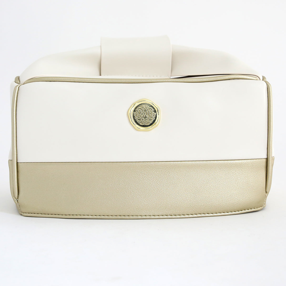 A two-tone handbag with cream and beige panels, gold medallion detail on the front, styled next to an Empress Mini Elite Dust Cover, displayed against a plain white background.