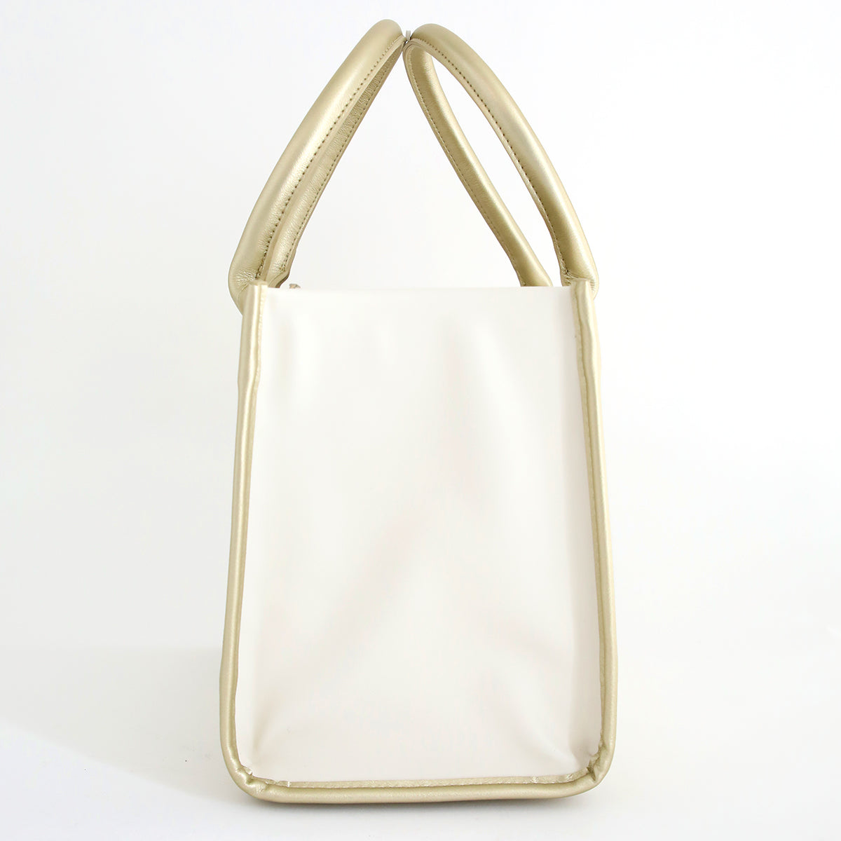 The Empress Mini Elite Tote Bag features a chic white design with gold handles and trim—perfect for Anna Griffin fans to carry their die cutting machine in style.