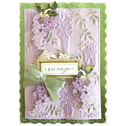 A decorative greeting card features purple flowers, a green ribbon bow, and a "Just For You" label on an embossed background made with Trellis and Pergola 3D Embossing Folders, framed by a matching green border.