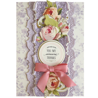 A decorative card features pink and cream flowers, an embossed lavender border made with Floral 3D 12" Border Dies, a pink ribbon, and the sentiment "Sending You My Sincere Thanks.