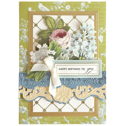 This decorative birthday card features floral illustrations, a white ribbon, and an ornate border crafted with the Floral 3D 12" Border Dies. "Happy Birthday to you" is elegantly scripted on the front.