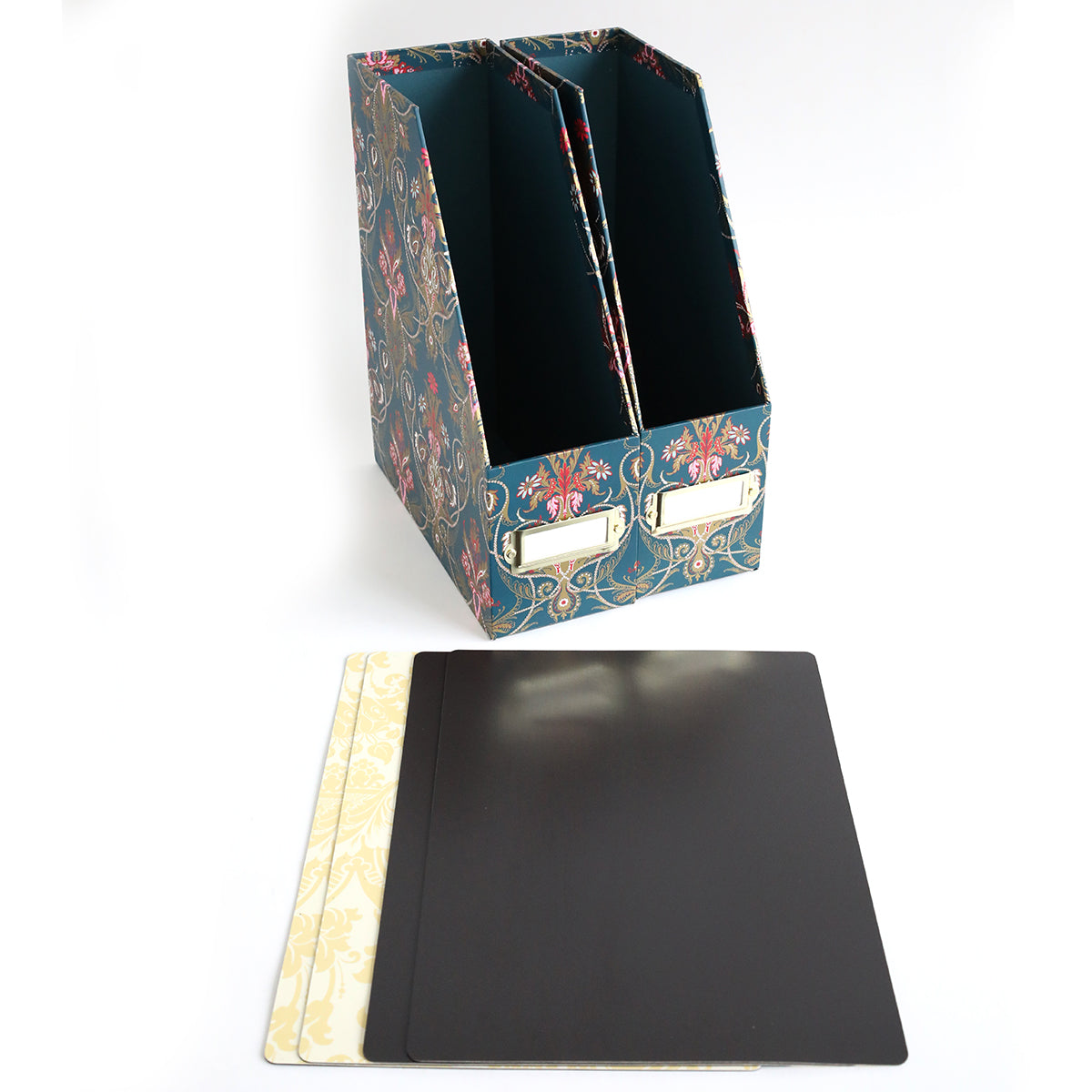 The Jasmine Die Storage Box, featuring a floral pattern and two magazine slots, stands behind three rectangular dividers—two patterned cream and one solid black—on a white surface, perfect for organizing dies or use as die storage.