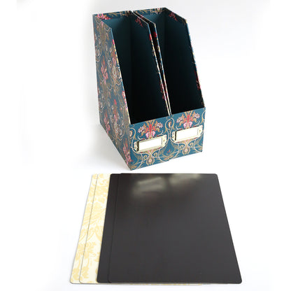 The Jasmine Die Storage Box, featuring a floral pattern and two magazine slots, stands behind three rectangular dividers—two patterned cream and one solid black—on a white surface, perfect for organizing dies or use as die storage.