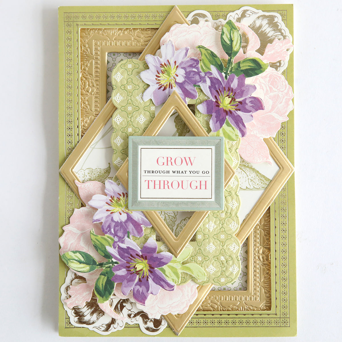 The Card Layer Photo Mat Bundle features layered gold frames with pink and purple floral designs and a "Grow through what you go through" message—ideal for cardmaking or as a charming scrapbooking accent.