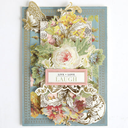 The Card Layer Photo Mat Bundle is a decorative floral greeting card with a butterfly and gold details, ideal for scrapbooking or cardmaking, featuring "LIVE • LOVE LAUGH" in the center.