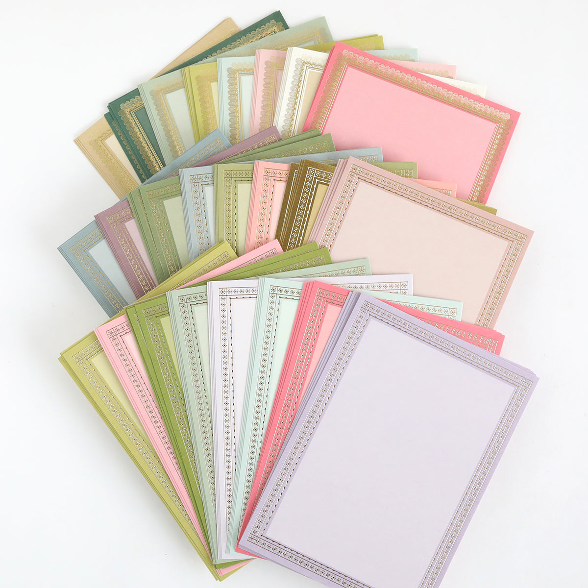 The Card Layer Photo Mat Bundle features pastel-colored blank cards with decorative borders, fanned out on a white background—ideal for scrapbooking and cardmaking projects.