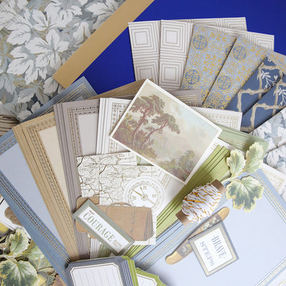 The Jack Ultimate Paper Crafting Collection includes patterned and plain stationery, postcards, tags, string, and envelopes—ideal for card making or scrapbooking—all beautifully arranged with decorative paper in the background.