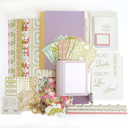 The Charlie Ultimate Paper Crafting Collection, featuring pastel patterned papers, floral cutouts, cardstock embellishments, printed cards, tags, borders, and twine spool, is arranged on a white background.