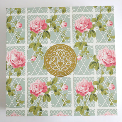 A decorative box with a lattice and rose pattern, featuring a gold seal reading "Anna Griffin | Create 2026 AUTOSHIP" in the center.