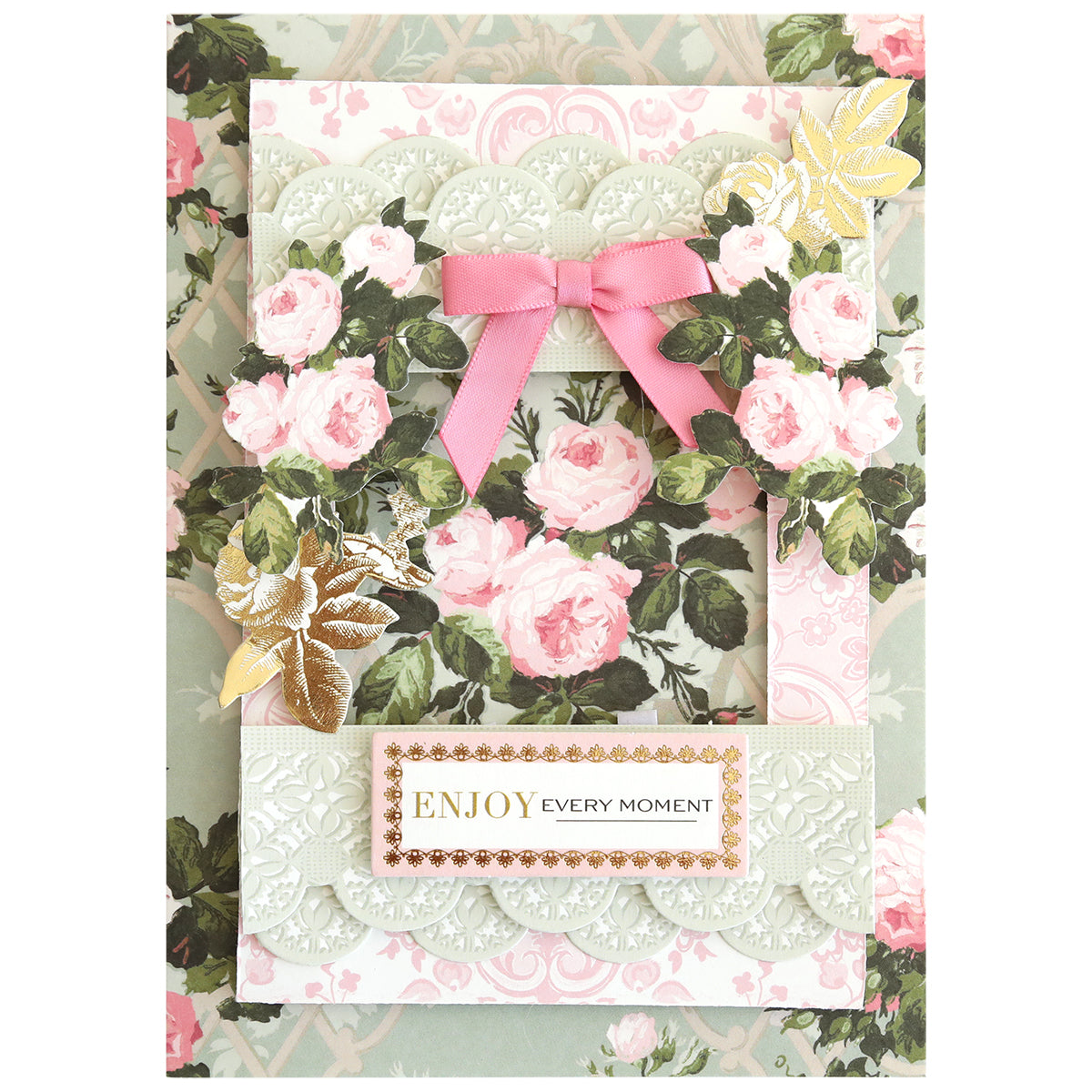 The Rose Ultimate Paper Crafting Collection features a greeting card with pink roses, gold leaves, and a pink ribbon bow. The card displays "ENJOY EVERY MOMENT" in elegant gold and black text—ideal for card making or paper crafting.