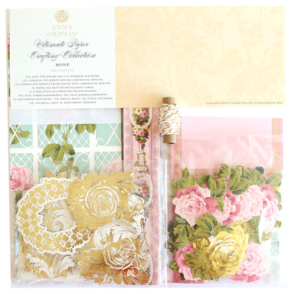 The Rose Ultimate Paper Crafting Collection includes gold floral stickers, pink and yellow paper flowers, twine, and patterned papers in a clear package—ideal for scrapbooking and card making.