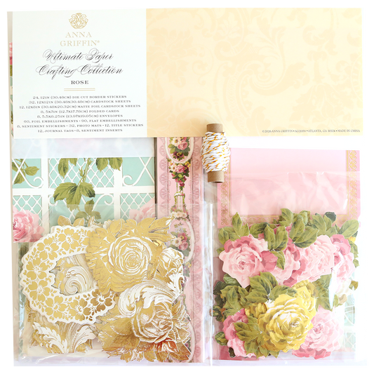 The Rose Ultimate Paper Crafting Collection includes gold floral stickers, pink and yellow paper flowers, twine, and patterned papers in a clear package—ideal for scrapbooking and card making.