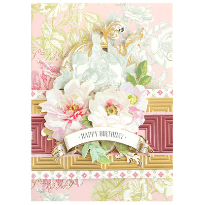 A decorative birthday card with white and pink flowers, gold accents, and a "Happy Birthday" banner on a pastel background, beautifully accented using Create Border, Frame and Shape Dies.