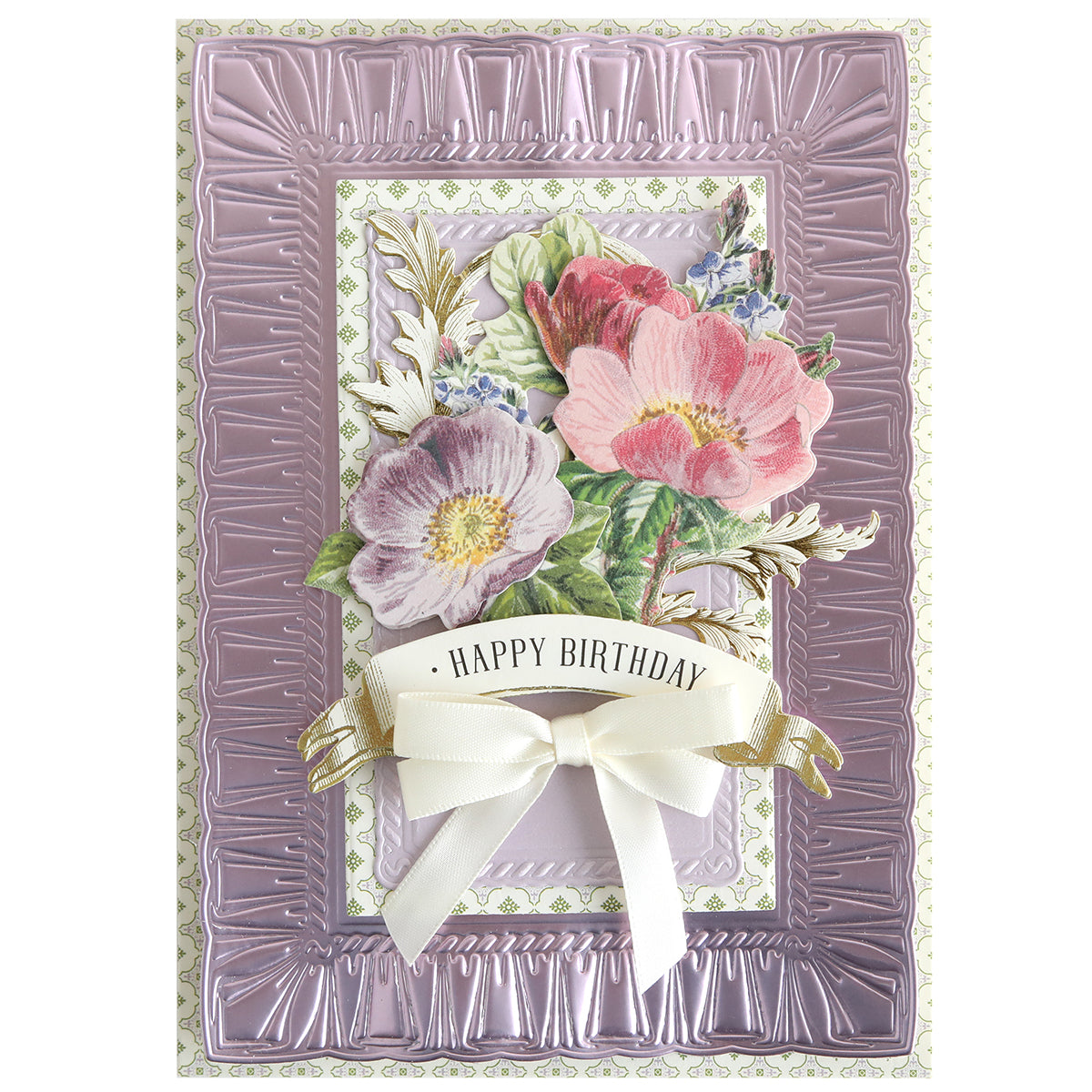 A decorative birthday card featuring embossed purple borders, floral designs, and a white ribbon bow with "Happy Birthday," crafted using Create Spring Frame Dies for an elegant touch.