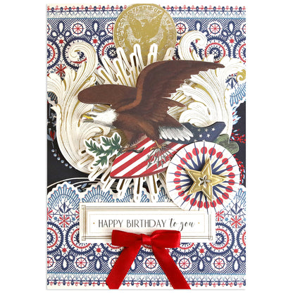 A birthday card with a bald eagle, patriotic symbols, gold accents, and a red velvet bow—perfect for Americana crafts or pairing with the Patriotic Papercrafting Kit with Dies. Message: "Happy Birthday to you.