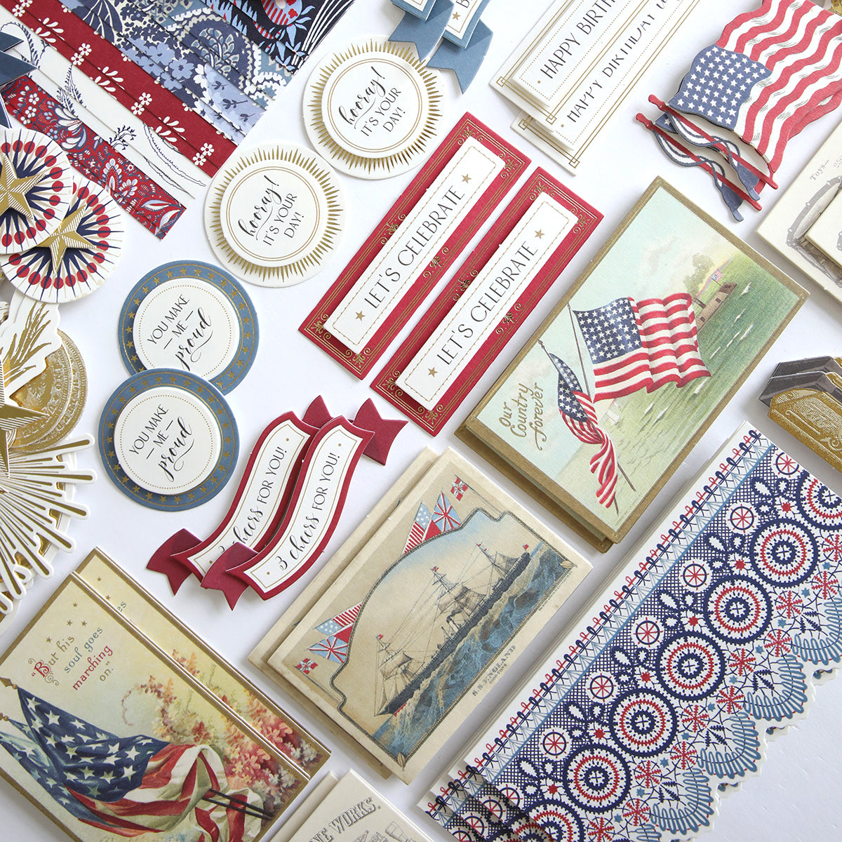 The Patriotic Papercrafting Kit with Dies includes vintage-style cards, banners, and decorations featuring American flags, ships, and red, white, and blue designs—perfect for Americana crafts or use with your favorite dies.