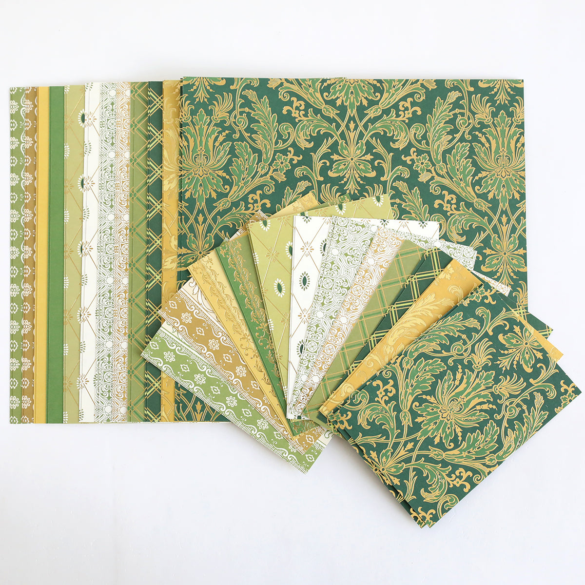 The Lucky for All Double Sided Cardstock, featuring green and gold foil patterns, is fanned out on a white background.