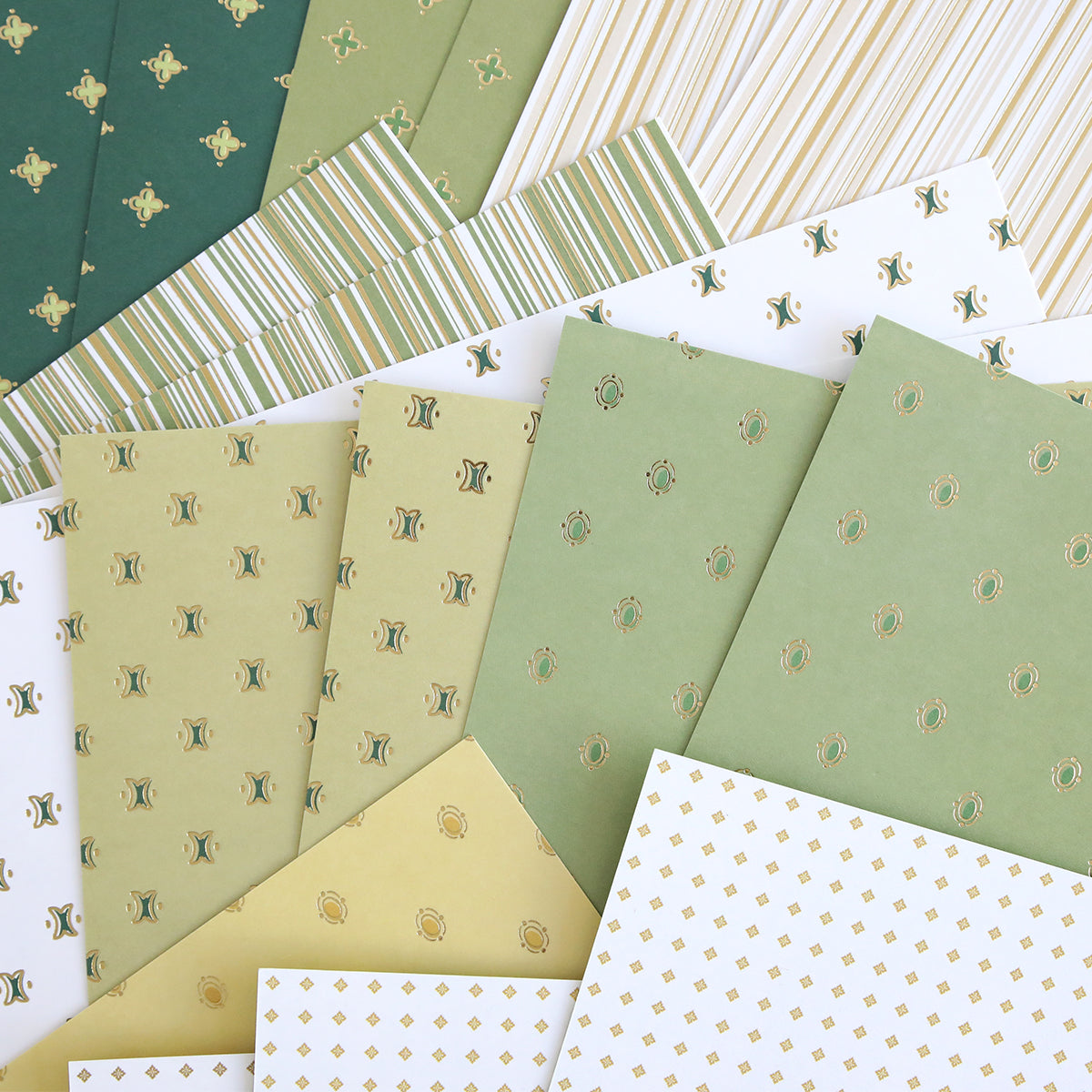 The Lucky for All Double Sided Cardstock is arranged in a fan shape, showcasing green, white, and yellow tones with stripes, dots, and geometric patterns.