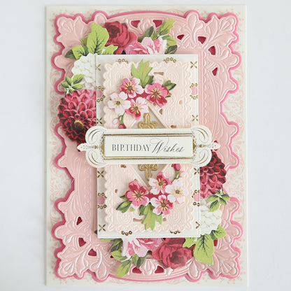 A decorative birthday card with layered pink and white embossed paper, pink floral designs, and a "Birthday Wishes" label, elegantly accented using the Lotus Concentric Frames 3D Die Set for a sophisticated papercraft finish.