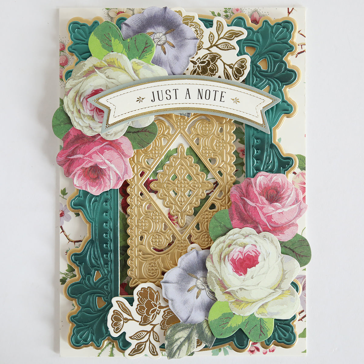 A decorative greeting card with gold, green, and floral designs featuring pink and white roses and a "Just a Note" banner, crafted using the Lotus Concentric Frames 3D Die Set for an elegant papercrafting finish.